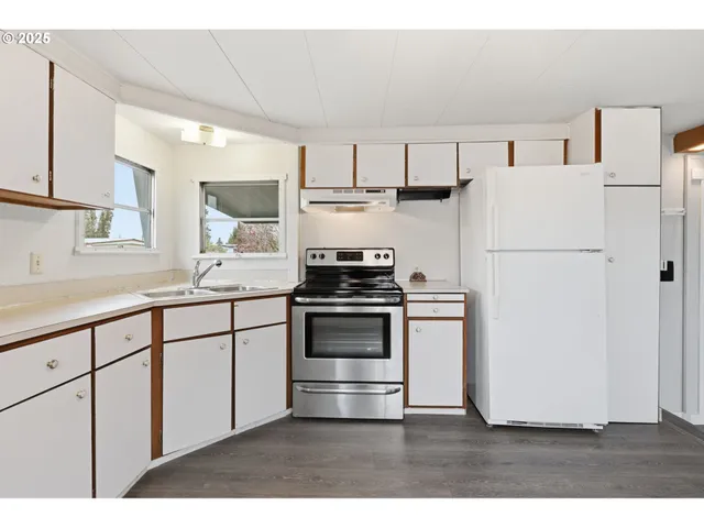 a kitchen with cabinets a stove and a sink