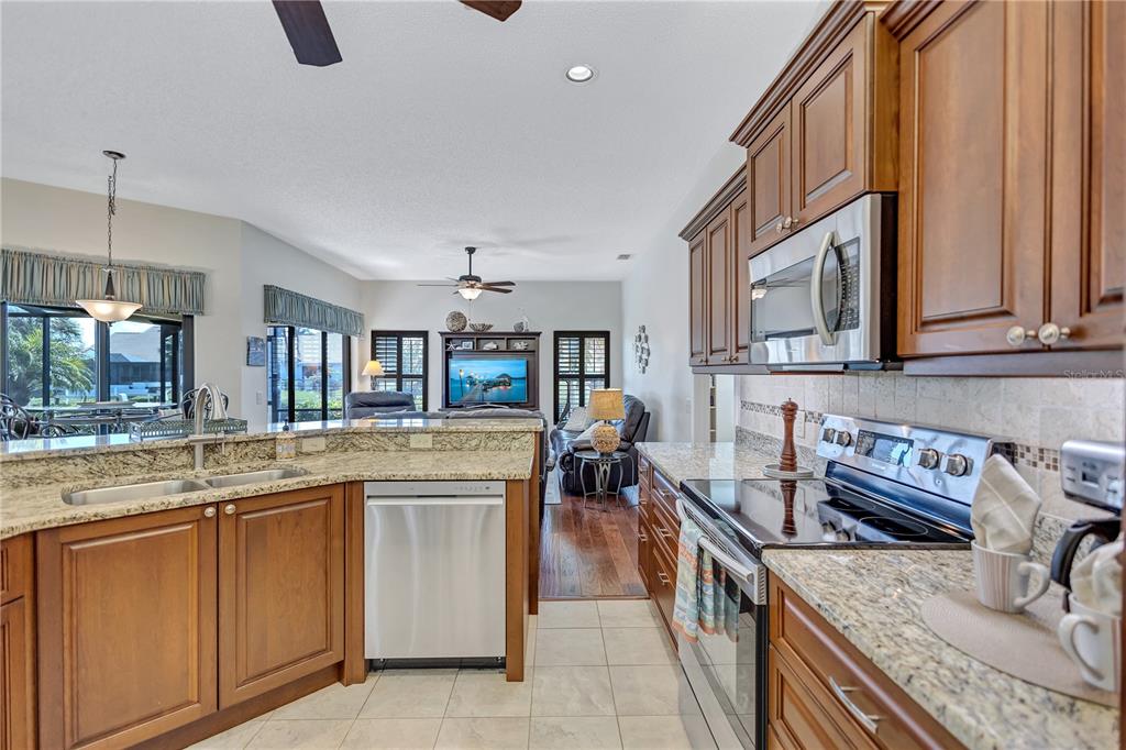 104 Inlets Boulevard, Unit 104 Nokomis, FL 34275 - Photo 17 of 66 a kitchen with stainless steel appliances granite countertop a sink and a stove