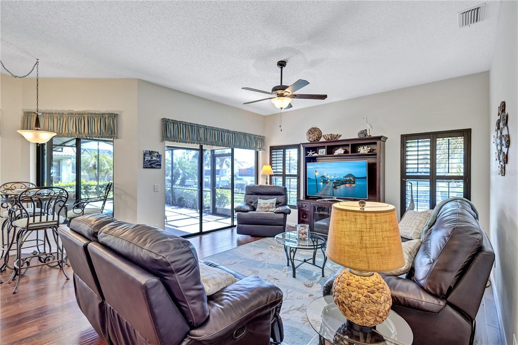 104 Inlets Boulevard, Unit 104 Nokomis, FL 34275 - Photo 23 of 66 a living room with furniture fireplace and a large window