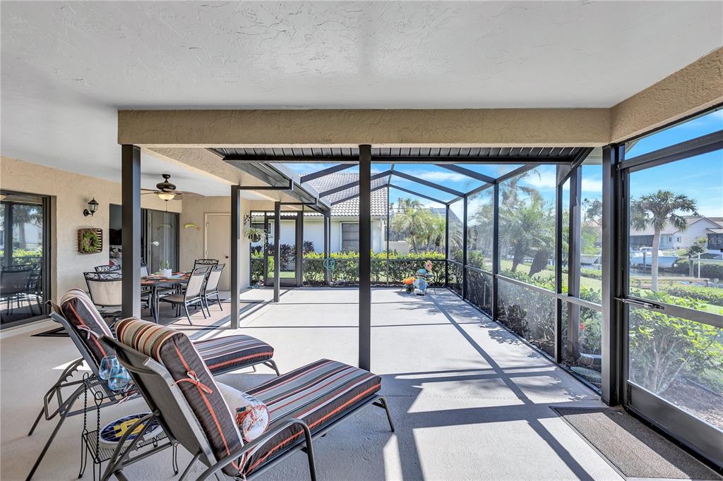 104 Inlets Boulevard, Unit 104 Nokomis, FL 34275 - Photo 27 of 66 a living room with furniture and a floor to ceiling window