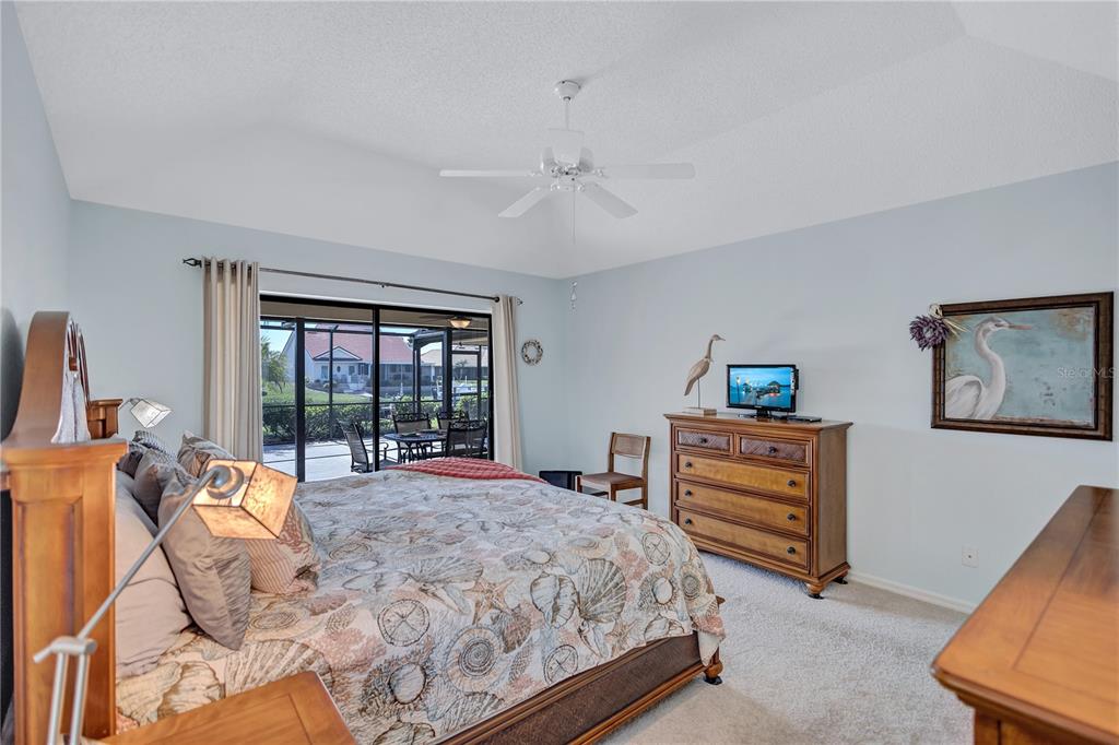 104 Inlets Boulevard, Unit 104 Nokomis, FL 34275 - Photo 29 of 66 a bed room with a bed and a chair