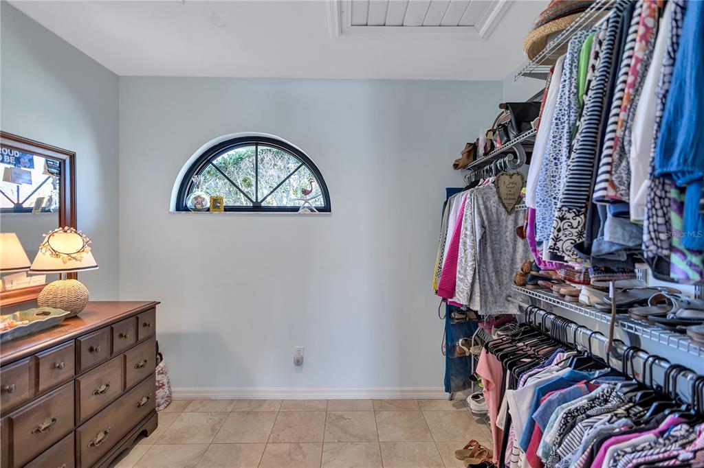 104 Inlets Boulevard, Unit 104 Nokomis, FL 34275 - Photo 36 of 66 a view of walk in closet with clothes