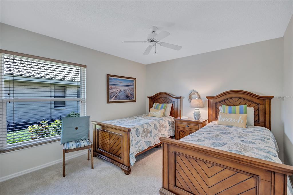 104 Inlets Boulevard, Unit 104 Nokomis, FL 34275 - Photo 41 of 66 a bedroom with two beds and a dresser
