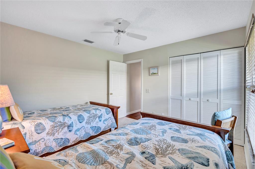104 Inlets Boulevard, Unit 104 Nokomis, FL 34275 - Photo 42 of 66 a bedroom with a large bed and a chandelier