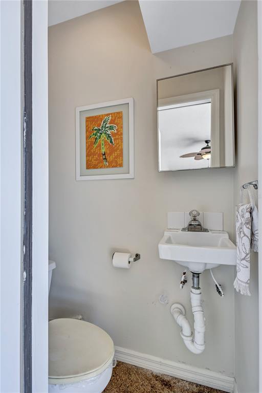 104 Inlets Boulevard, Unit 104 Nokomis, FL 34275 - Photo 44 of 66 a bathroom with a sink mirror and toilet