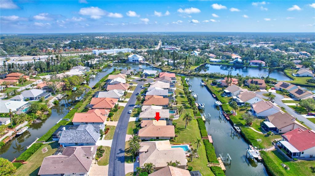 104 Inlets Boulevard, Unit 104 Nokomis, FL 34275 - Photo 64 of 66 an aerial view of residential houses with outdoor space