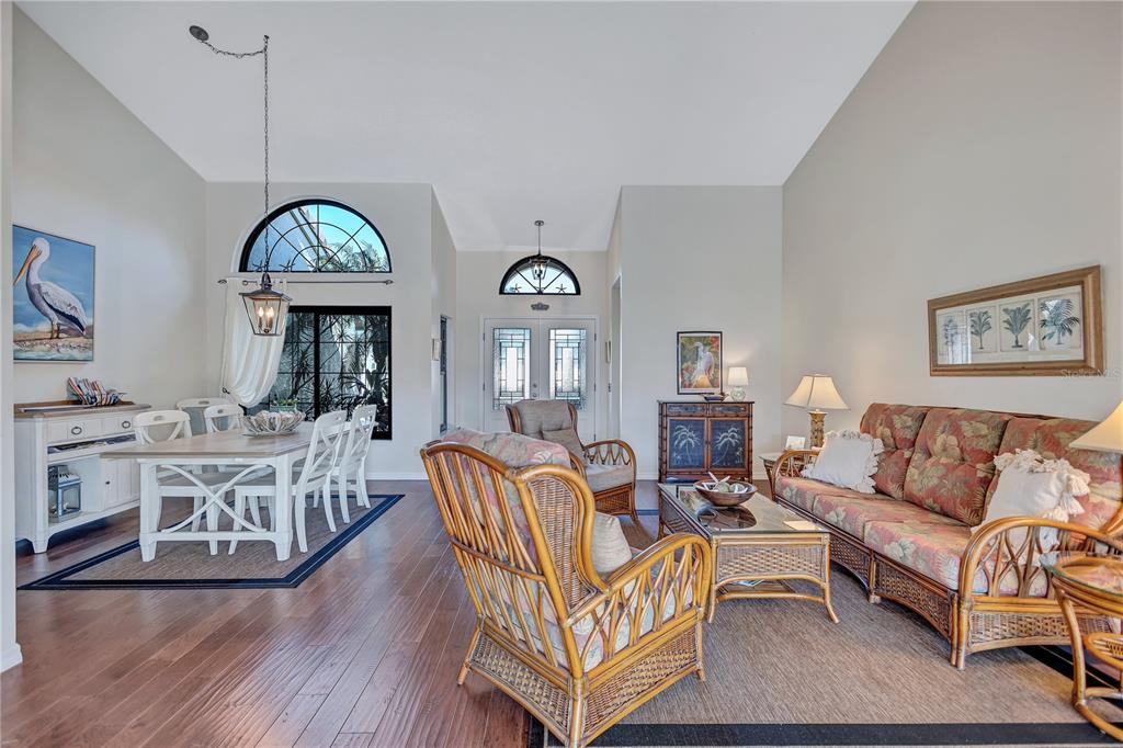 104 Inlets Boulevard, Unit 104 Nokomis, FL 34275 - Photo 8 of 66 a living room with furniture a window and wooden floor