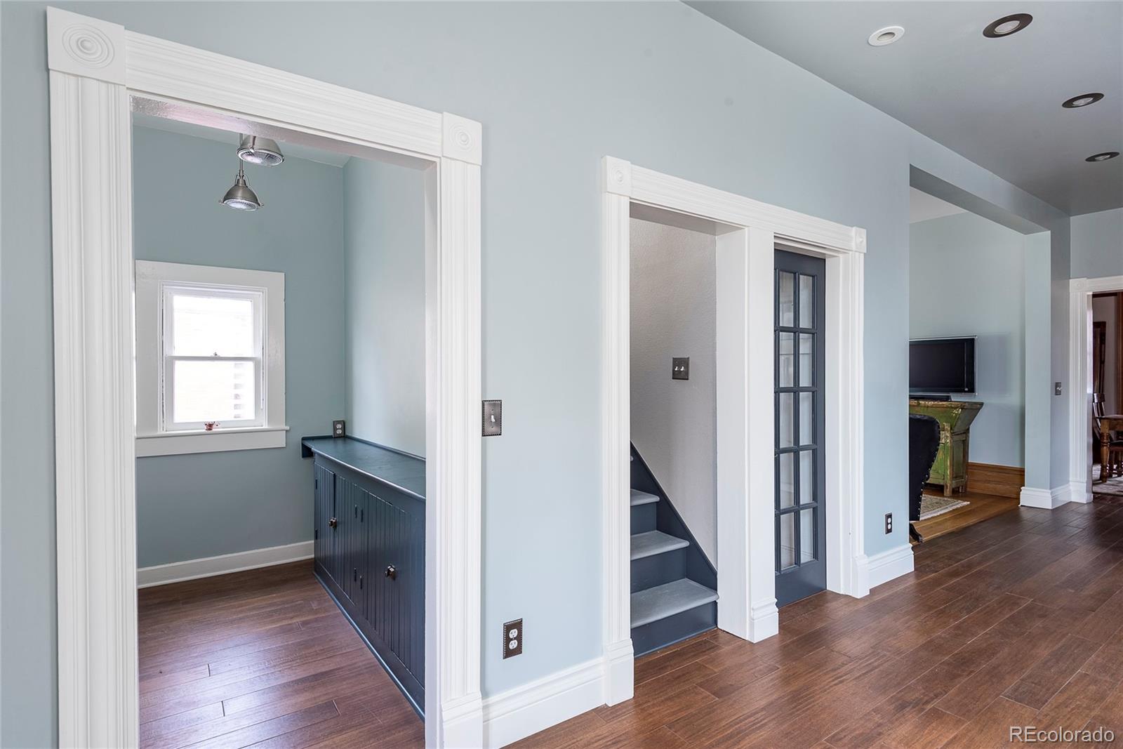 131 Sherman Street Denver, CO 80203 - Photo 12 of 36 a view of a hallway with wooden floors and a bathroom
