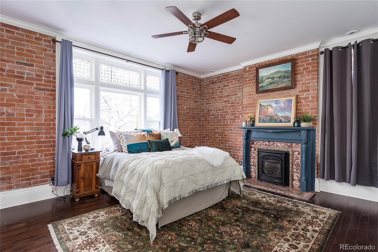 131 Sherman Street Denver, CO 80203 - Photo 17 of 36 a bed room with a bed and a fireplace