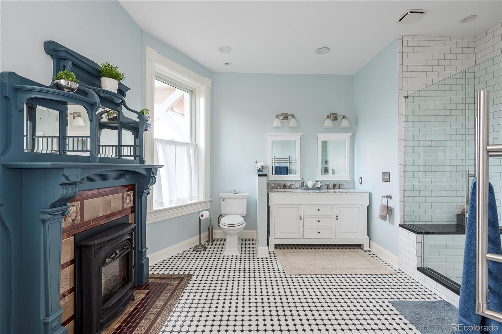 131 Sherman Street Denver, CO 80203 - Photo 21 of 36 a bathroom with a sink a toilet and shower