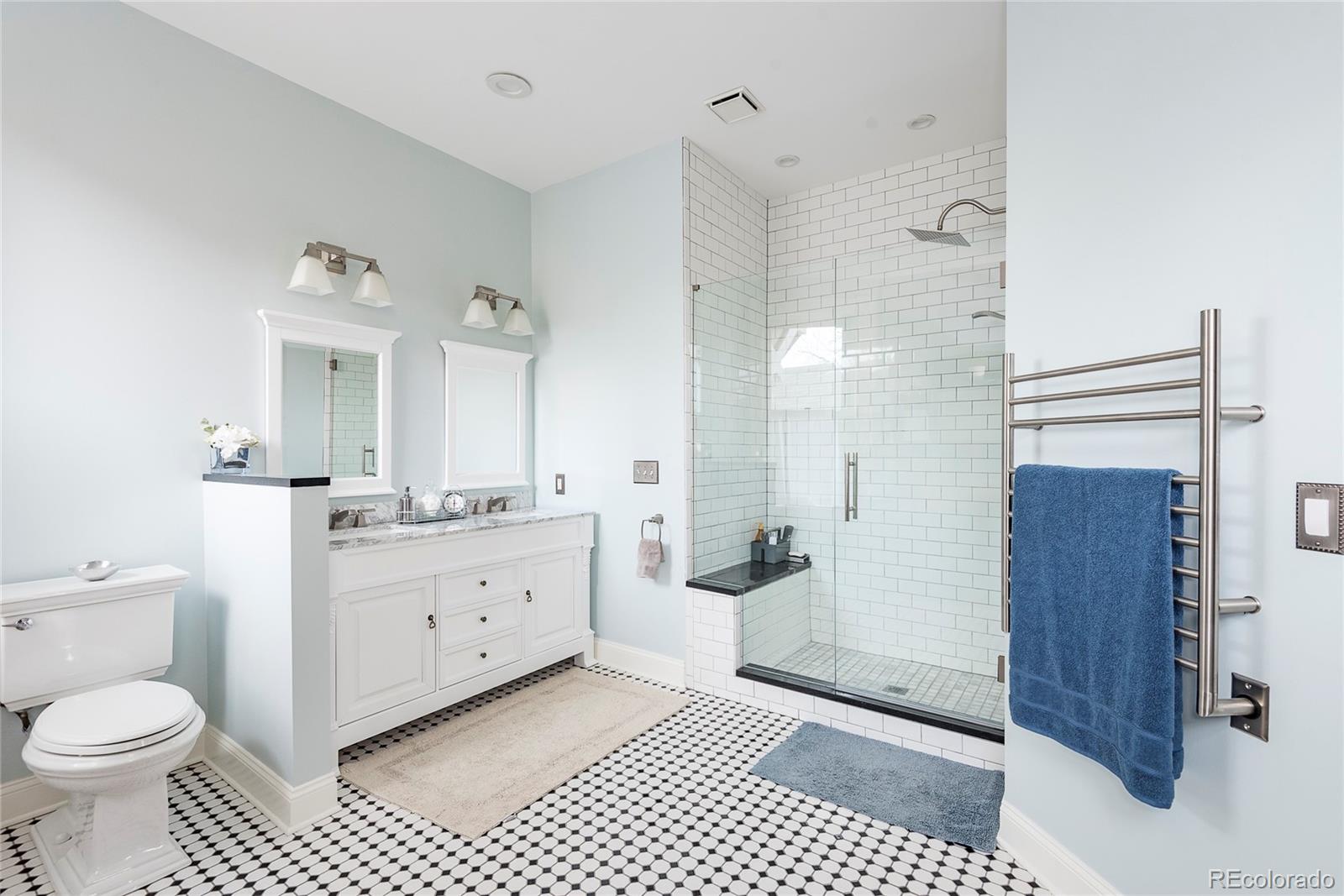 131 Sherman Street Denver, CO 80203 - Photo 22 of 36 a bathroom with a sink a toilet a mirror and shower