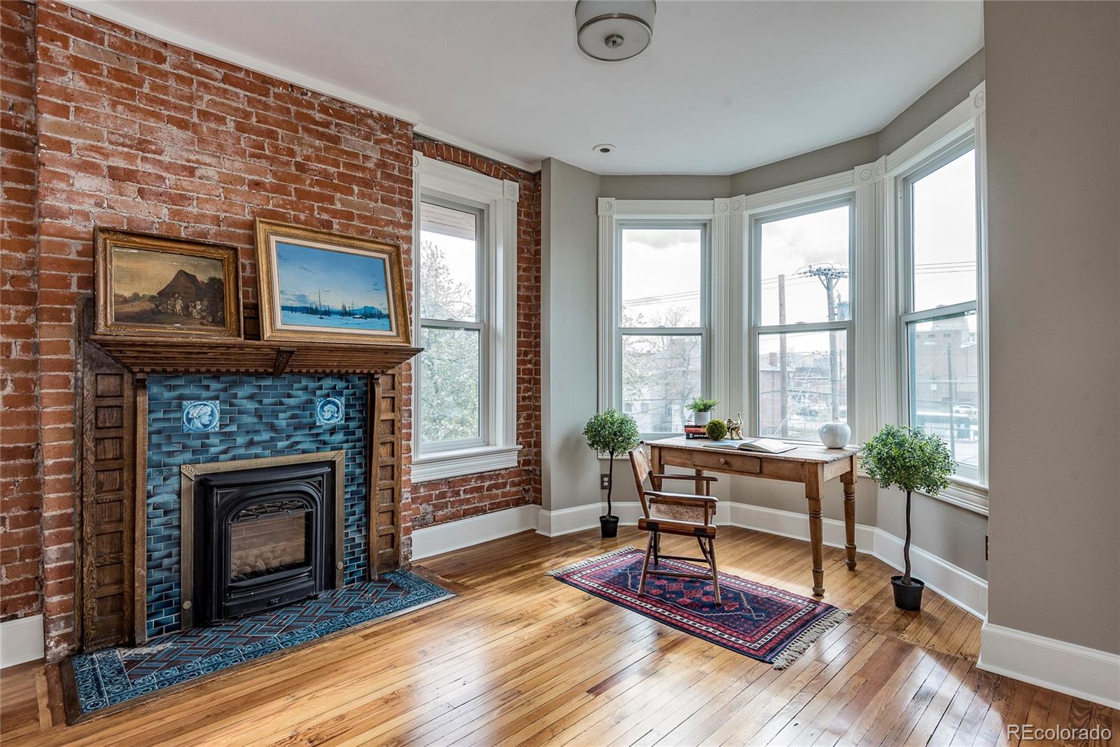131 Sherman Street Denver, CO 80203 - Photo 26 of 36 a living room with furniture fireplace and window
