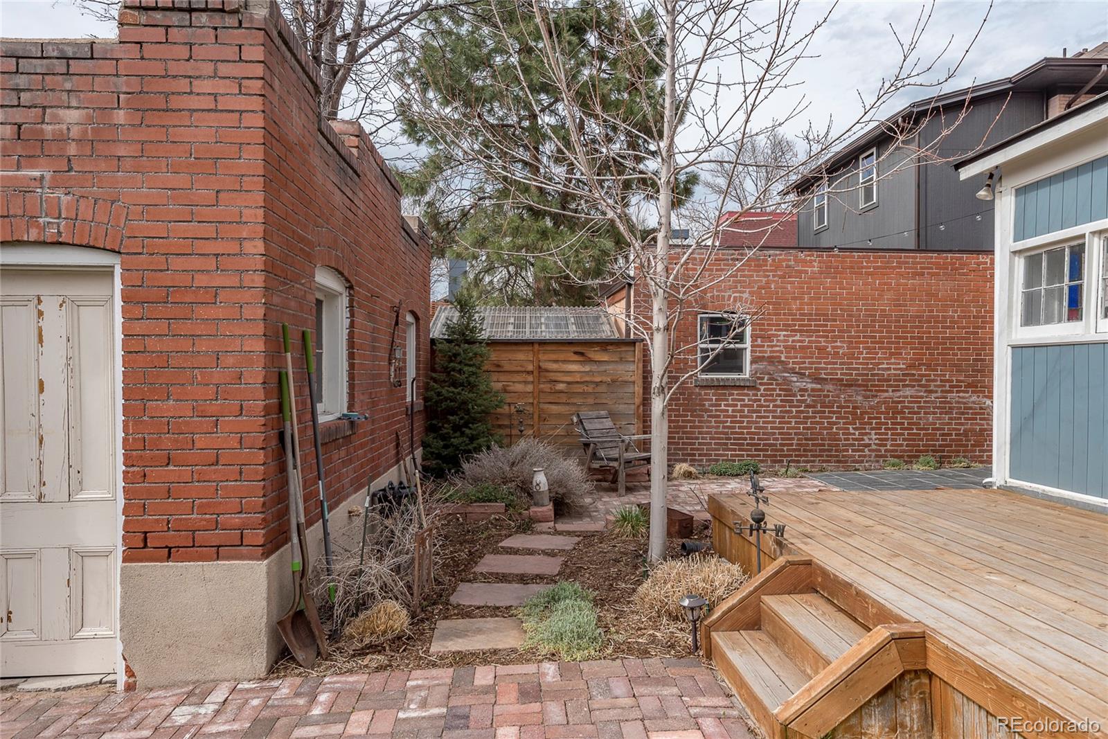 131 Sherman Street Denver, CO 80203 - Photo 35 of 36 a backyard of a house with outdoor seating