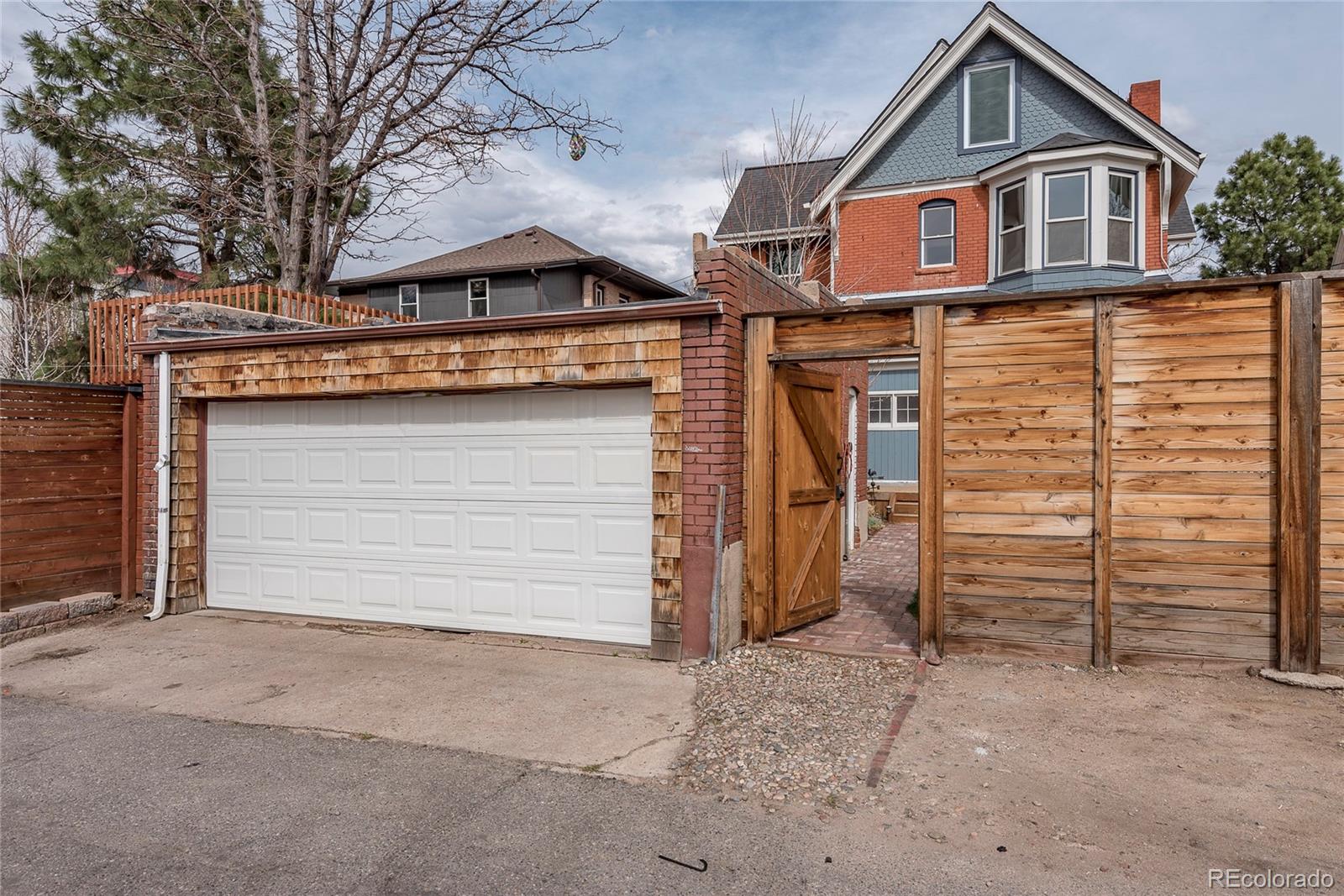 131 Sherman Street Denver, CO 80203 - Photo 36 of 36 a front view of a house with a yard and garage