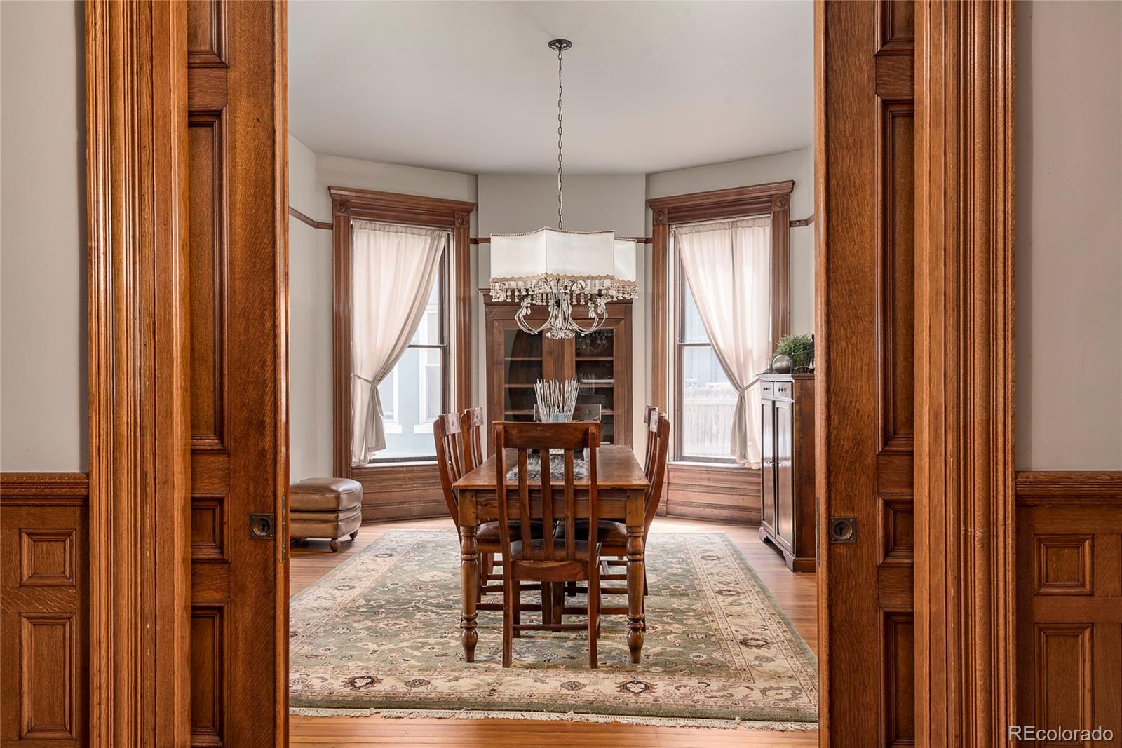 131 Sherman Street Denver, CO 80203 - Photo 7 of 36 a dining room with furniture window and wooden floor