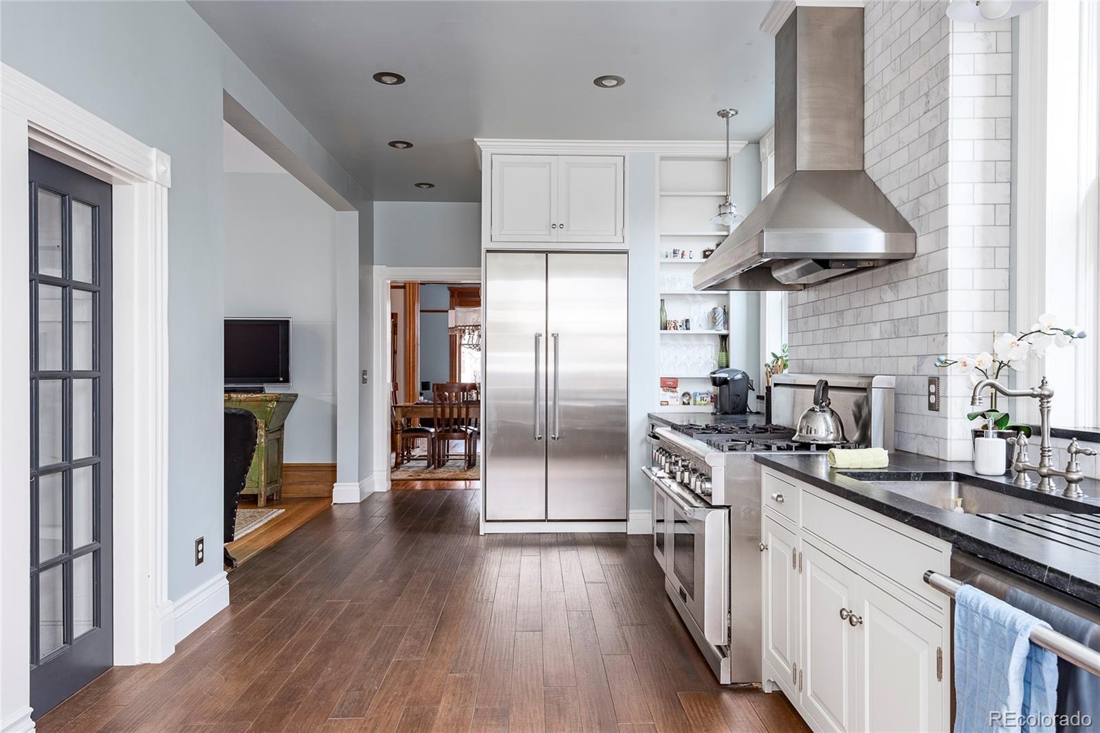 131 Sherman Street Denver, CO 80203 - Photo 10 of 36 a kitchen with stainless steel appliances a sink dishwasher a refrigerator and a stove