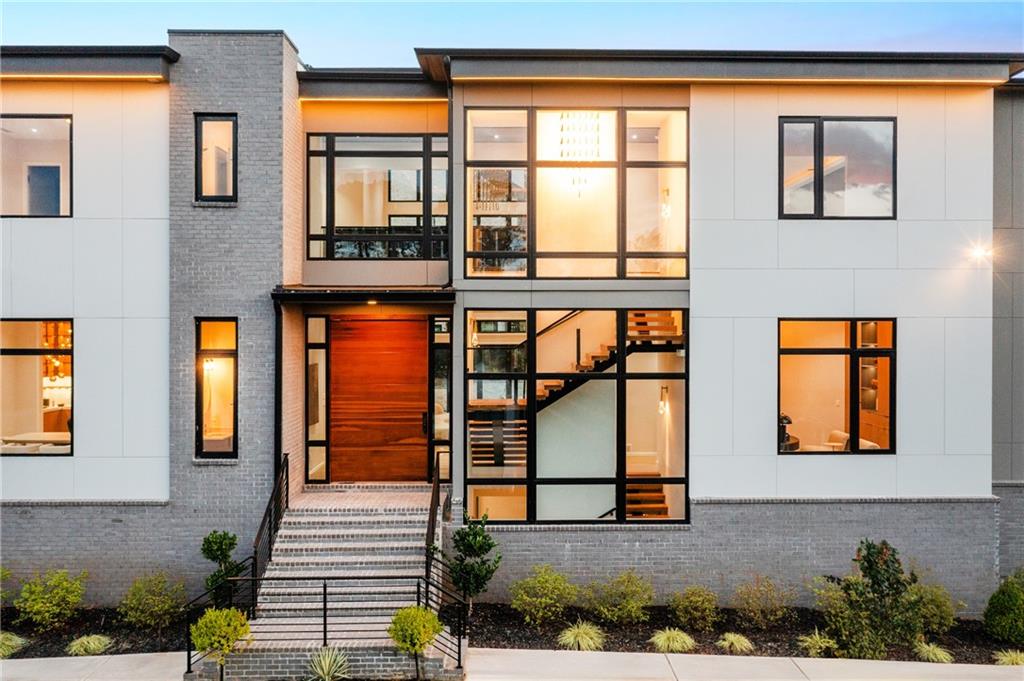 4232 Edgewood Court Marietta, GA 30068 - Photo 13 of 72 a view of a brick house with many windows and couches