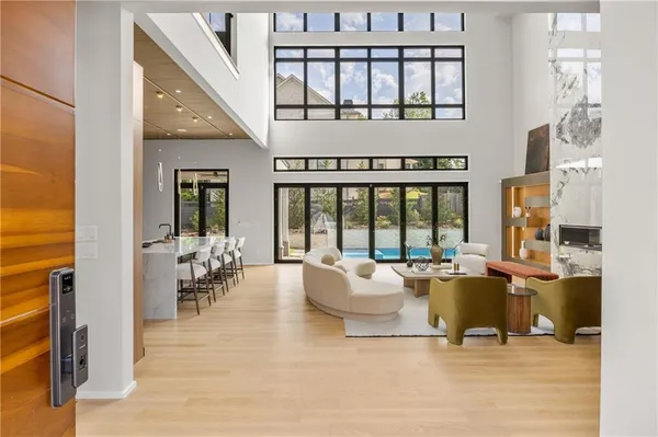 a living room with furniture and large windows