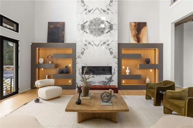 a living room with furniture large window and a table