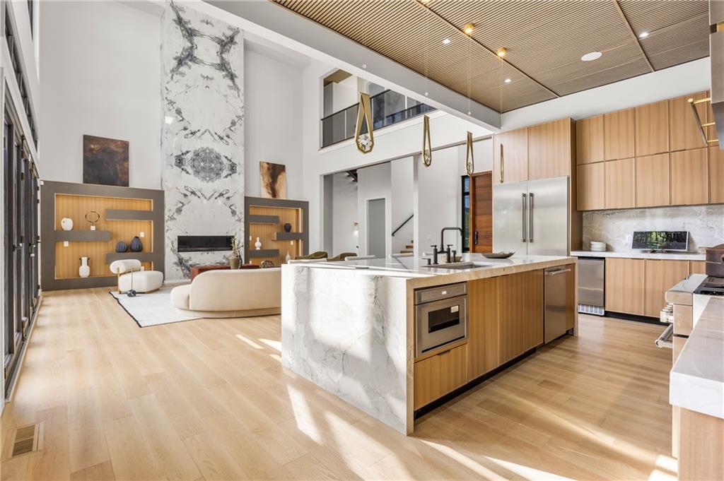 4232 Edgewood Court Marietta, GA 30068 - Photo 30 of 72 a large white kitchen with cabinets a sink a window and a couch