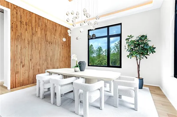 a view of a hallway with the couches and chandelier