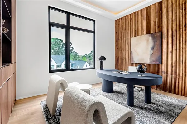 a spacious bedroom with a bed a couch and a chandelier