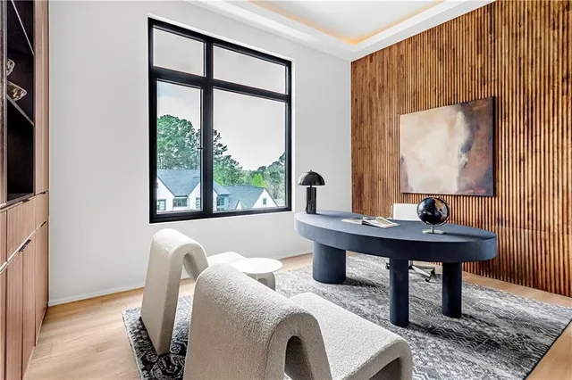 a spacious bedroom with a bed a couch and a chandelier