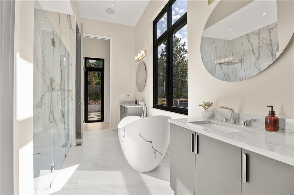4232 Edgewood Court Marietta, GA 30068 - Photo 41 of 72 a en suite bathroom with a granite countertop sink and a mirror