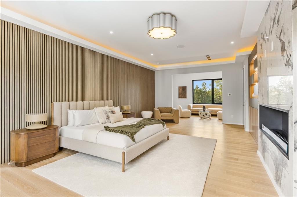 4232 Edgewood Court Marietta, GA 30068 - Photo 47 of 72 a spacious bedroom with a bed a couch and a chandelier