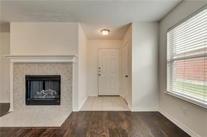 2112 Pecan Creek Drive Mesquite, TX 75181 - Photo 3 of 11 a view of a livingroom with wooden floor and a fireplace