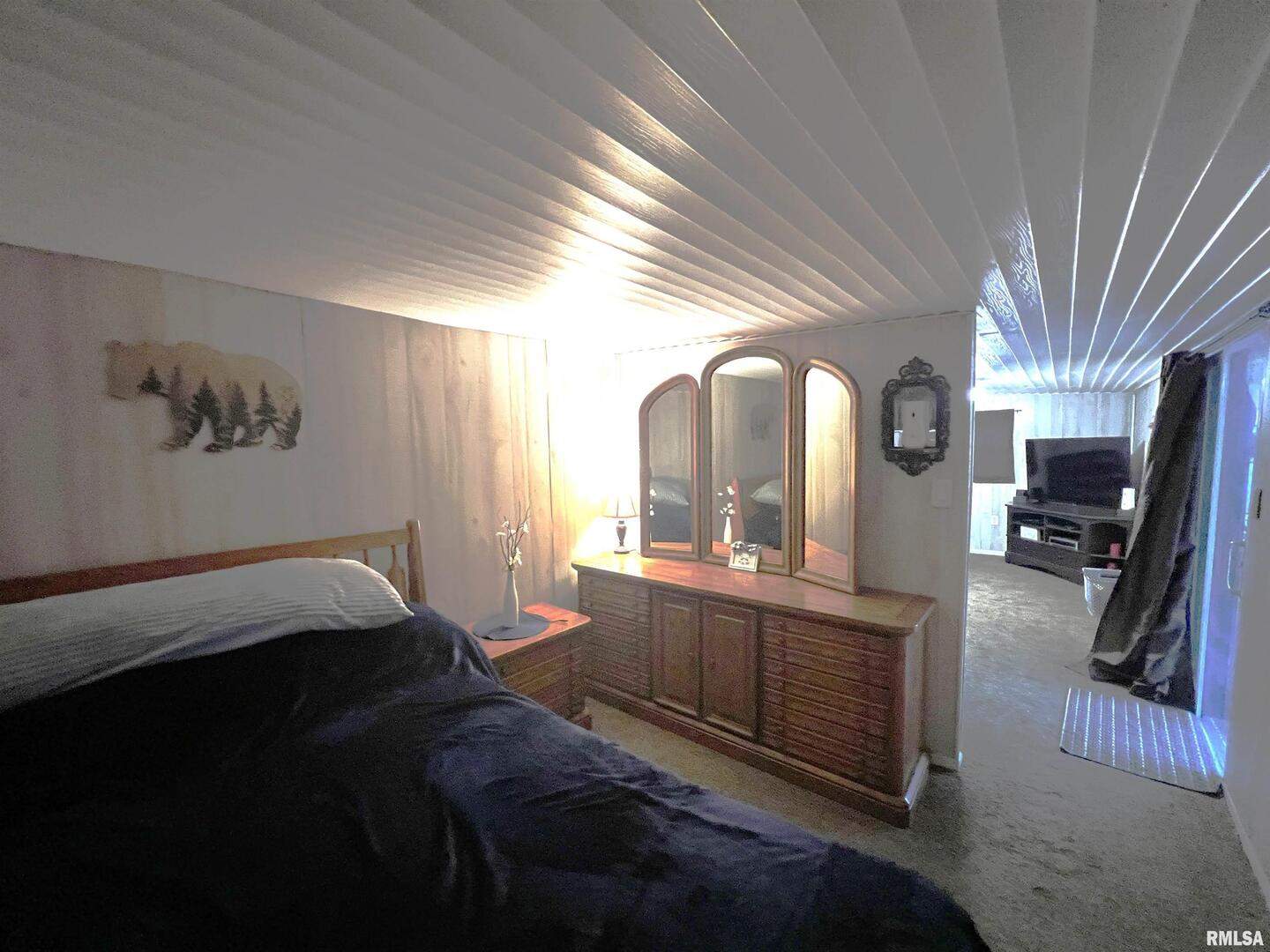 4 Victory Lane Marion, IL 62959 - Photo 16 of 26 a bedroom with a bed a mirror on dresser and a large window