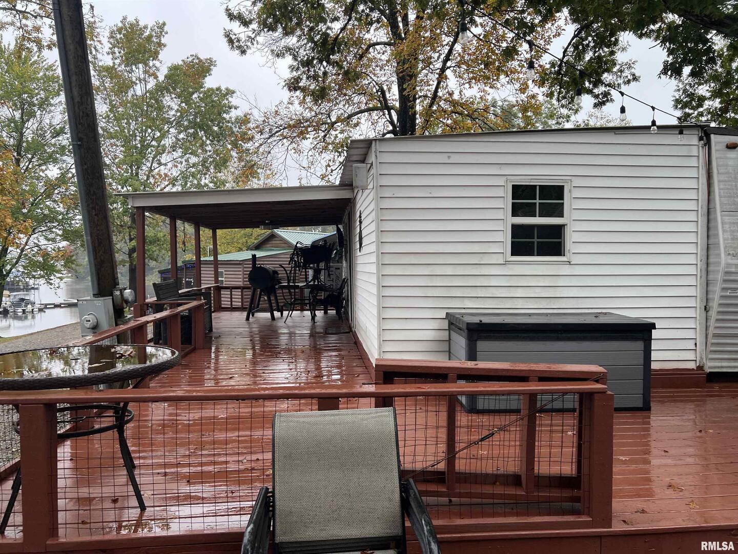4 Victory Lane Marion, IL 62959 - Photo 8 of 26 a view of a patio with table and chairs potted plants with wooden floor and fence
