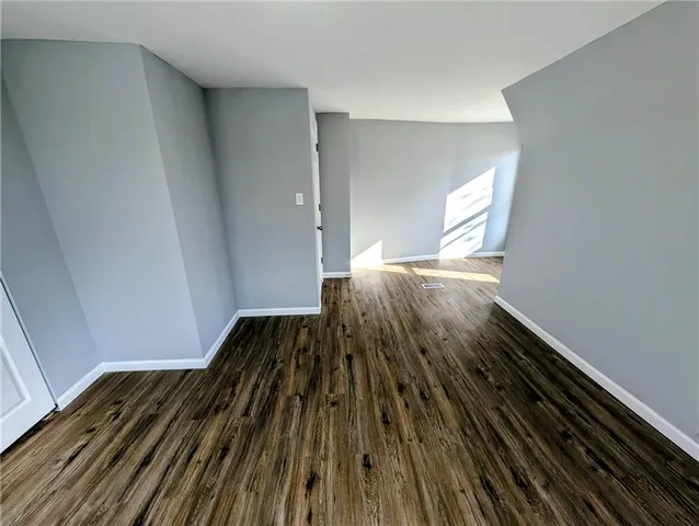 a view of wooden floor in a bedroom