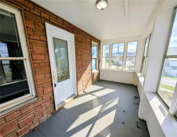 a view of an entryway with wooden floor and windows