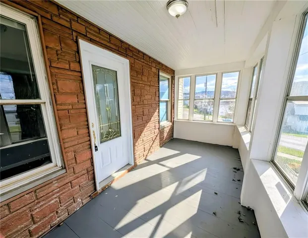 a view of an entryway with wooden floor and windows
