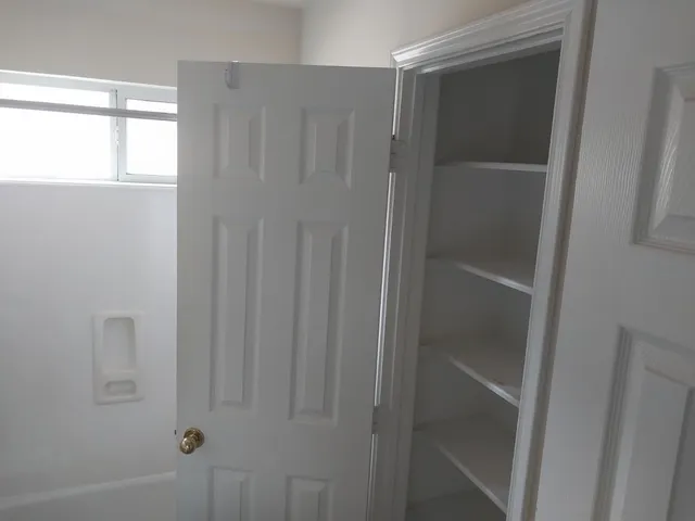 a view of a hallway to a window