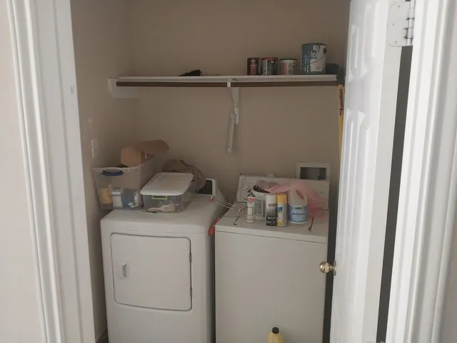 a view of backyard with wooden fence and a bench