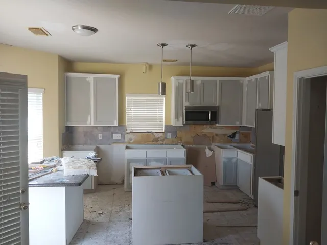 a kitchen with a sink stove and refrigerator
