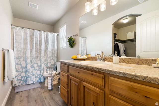 1393 West 150 North Springville, UT 84663 - Photo 13 of 31 Bathroom featuring a single vanity with a laminate countertop, wood-finish cabinetry, and a shower/tub combination