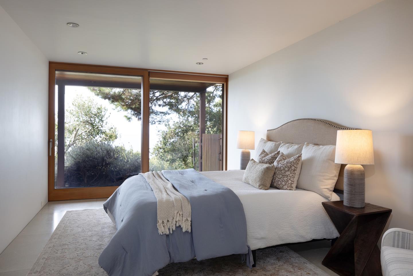 140 Boyd Way Carmel, CA 93923 - Photo 32 of 40 a bedroom with a bed and a lamp next to a window