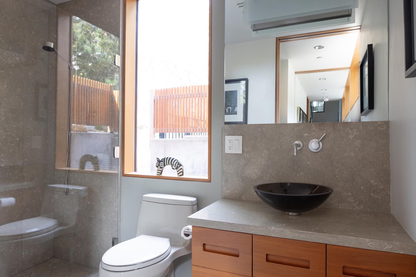 140 Boyd Way Carmel, CA 93923 - Photo 33 of 40 a bathroom with a granite countertop sink a toilet a mirror and window