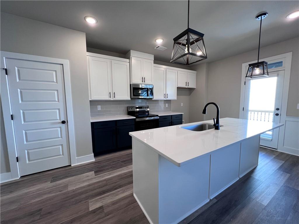23 Rock Pk Way, Unit 26 Tucker, GA 30084 - Photo 11 of 28 a kitchen with kitchen island a sink stainless steel appliances and cabinets