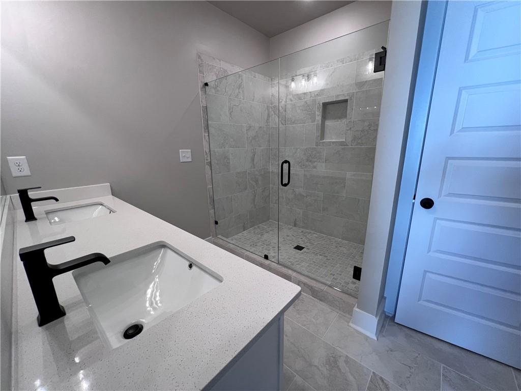 23 Rock Pk Way, Unit 26 Tucker, GA 30084 - Photo 25 of 28 a bathroom with a sink and a shower