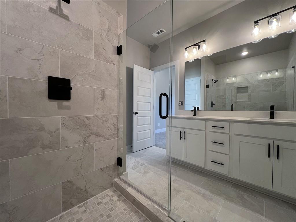 23 Rock Pk Way, Unit 26 Tucker, GA 30084 - Photo 26 of 28 a spacious bathroom with a double vanity sink a mirror and shower