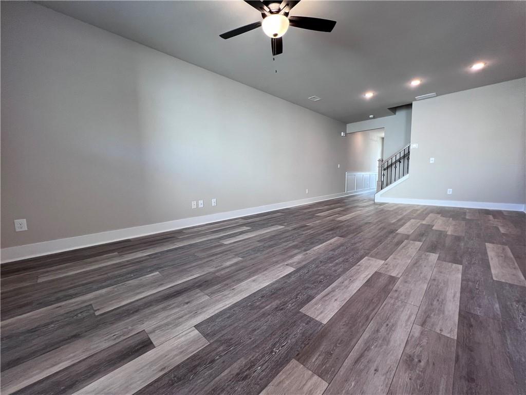 23 Rock Pk Way, Unit 26 Tucker, GA 30084 - Photo 8 of 28 wooden floor in an empty room with a chandelier fan