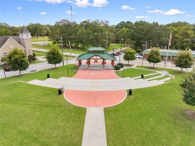 a view of a swimming pool with a yard and a fountain