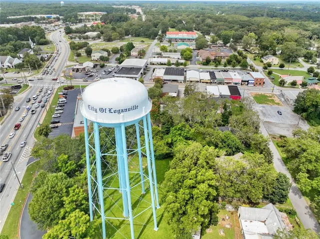 an aerial view of residential house with an outdoor space and seating