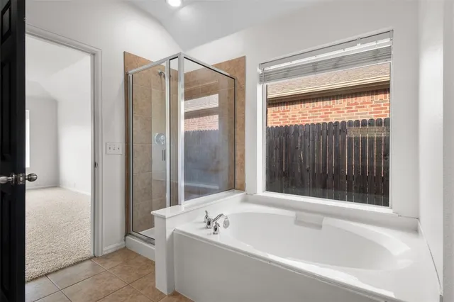 a spacious bathroom with a double vanity sink a mirror and a bathtub