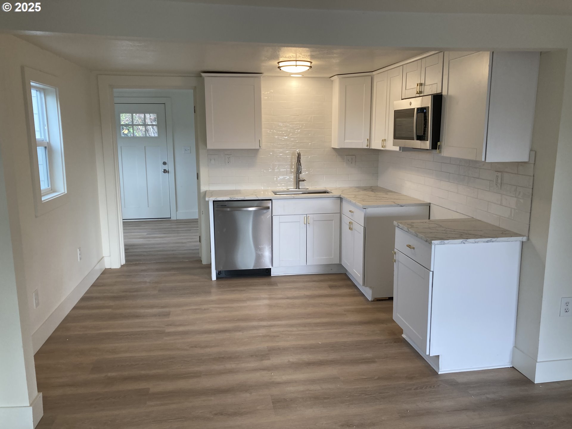 295 Knapp Street Eugene, OR 97404 - Photo 3 of 6 a kitchen with stainless steel appliances granite countertop a sink stove and refrigerator