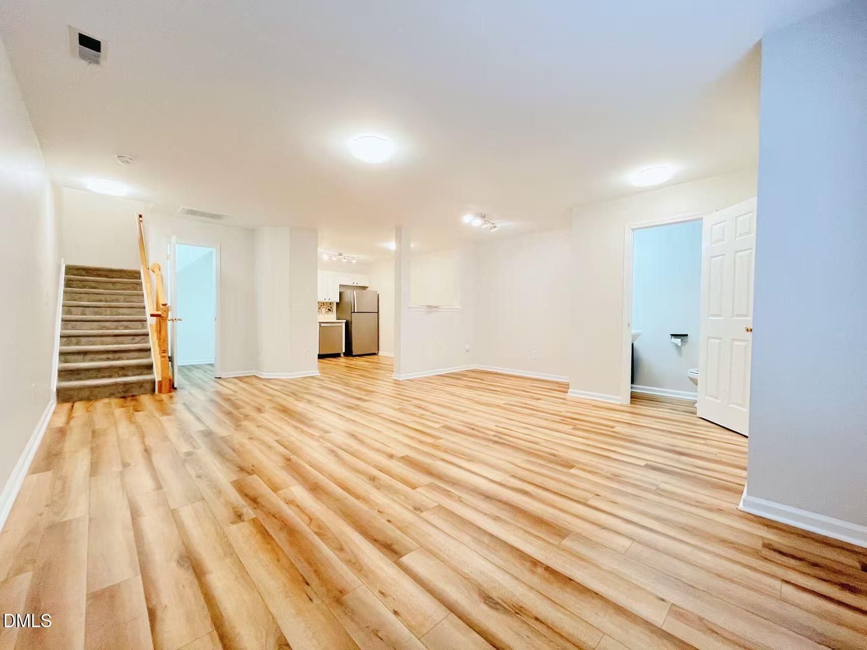 3040 Barrymore Street, Unit 108 Raleigh, NC 27603 - Photo 2 of 13 a view of empty room with wooden floor